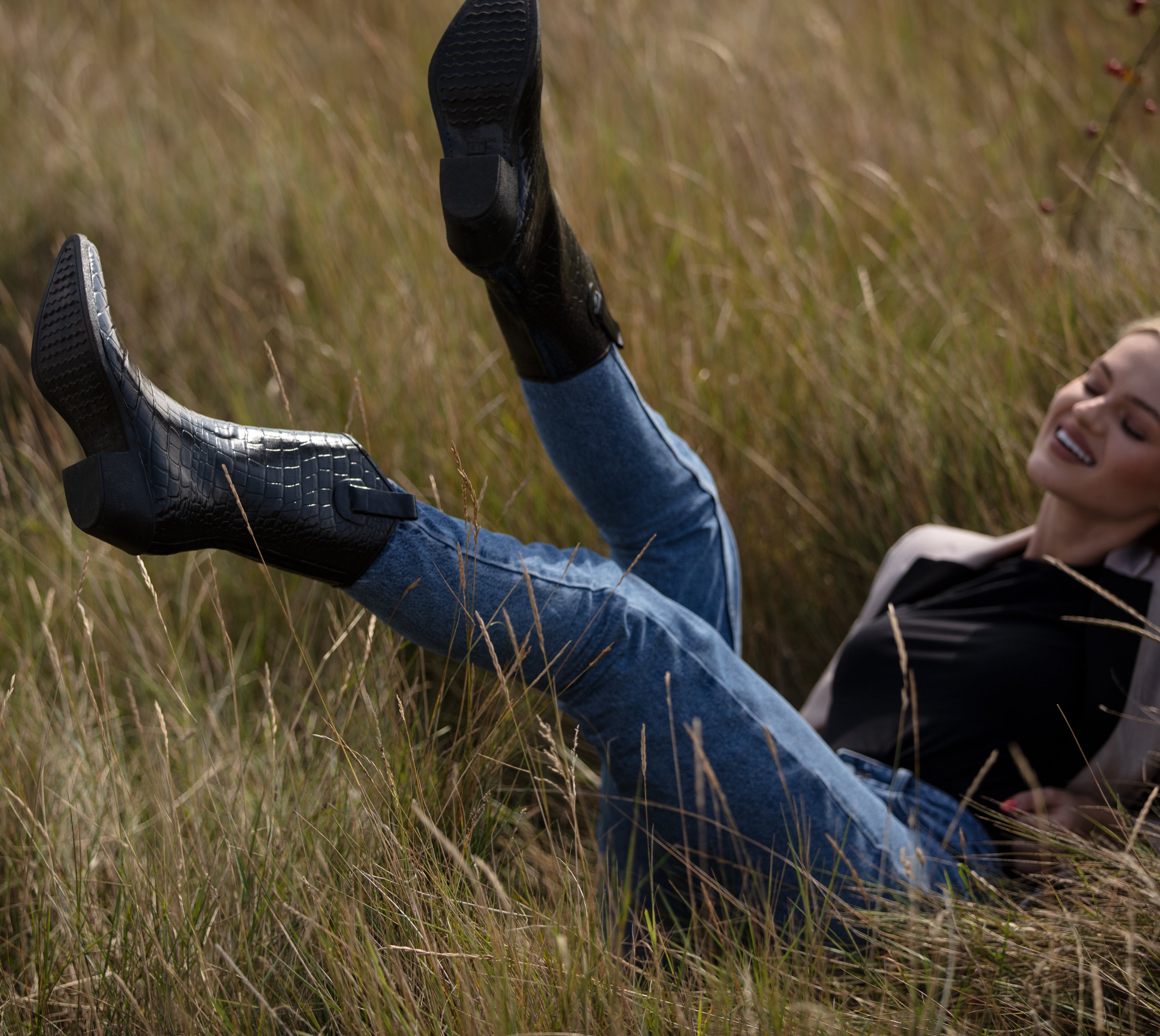 Lying in the long grass kicking feet in the air wearing Talolo urban cowboy boots wellies