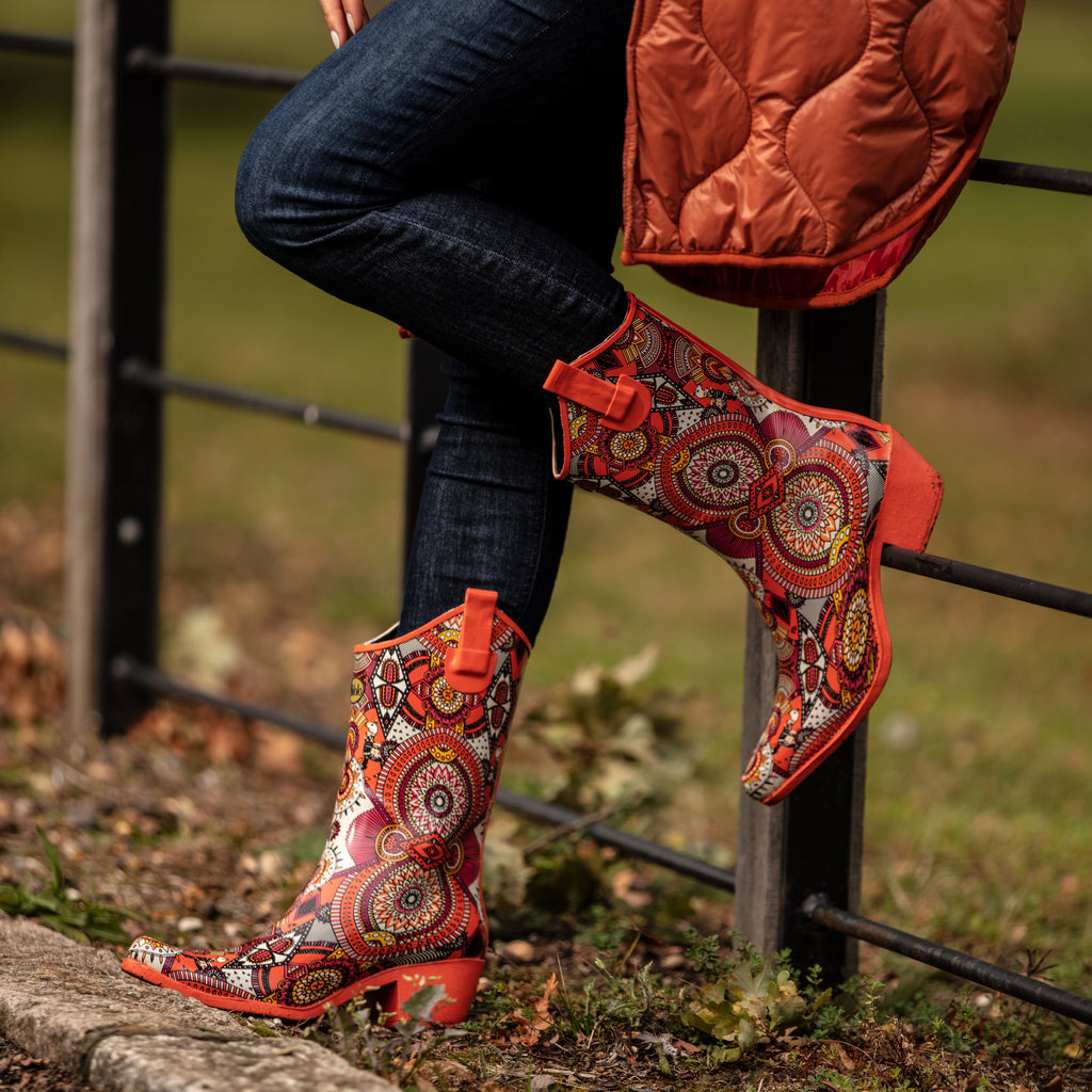 Zesty and full of life, these Talolo Women's orange aztec patterned, funky cowboy welly boots are heeled to give you sophistication and will reach the middle of the calf. Lined for comfort.