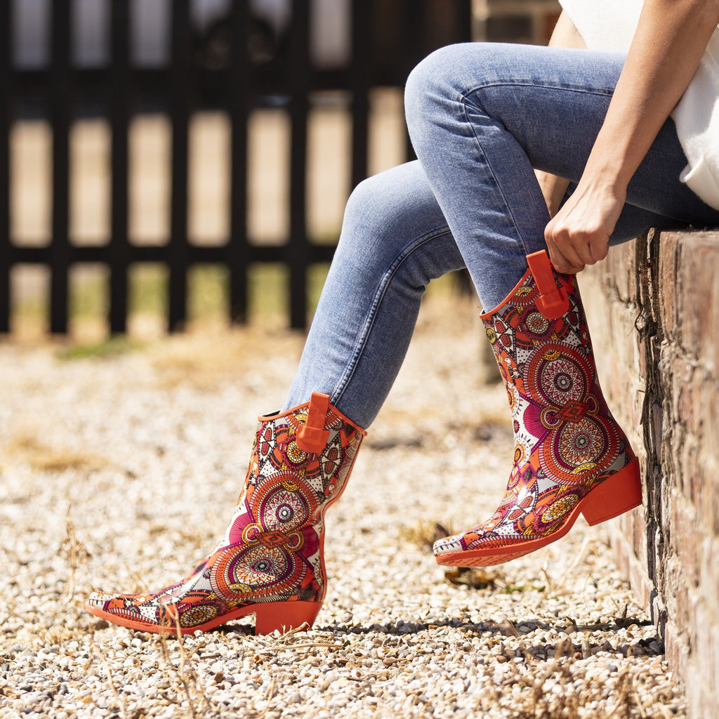 Zesty and full of life, these Talolo Women's orange aztec patterned, funky cowboy welly boots are heeled to give you sophistication and will reach the middle of the calf. Lined for comfort.