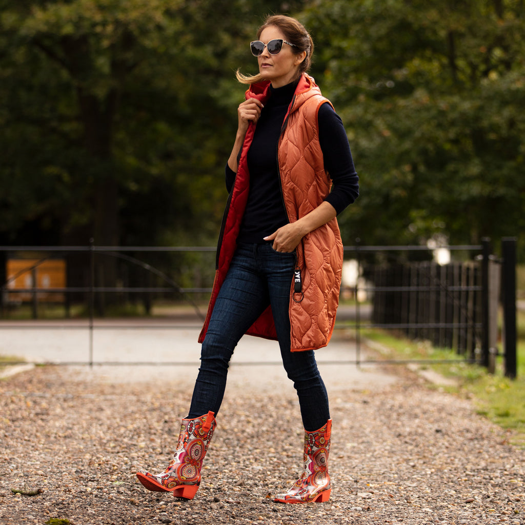 Zesty and full of life, these Talolo Women's orange aztec patterned, funky cowboy welly boots are heeled to give you sophistication and will reach the middle of the calf. Lined for comfort.